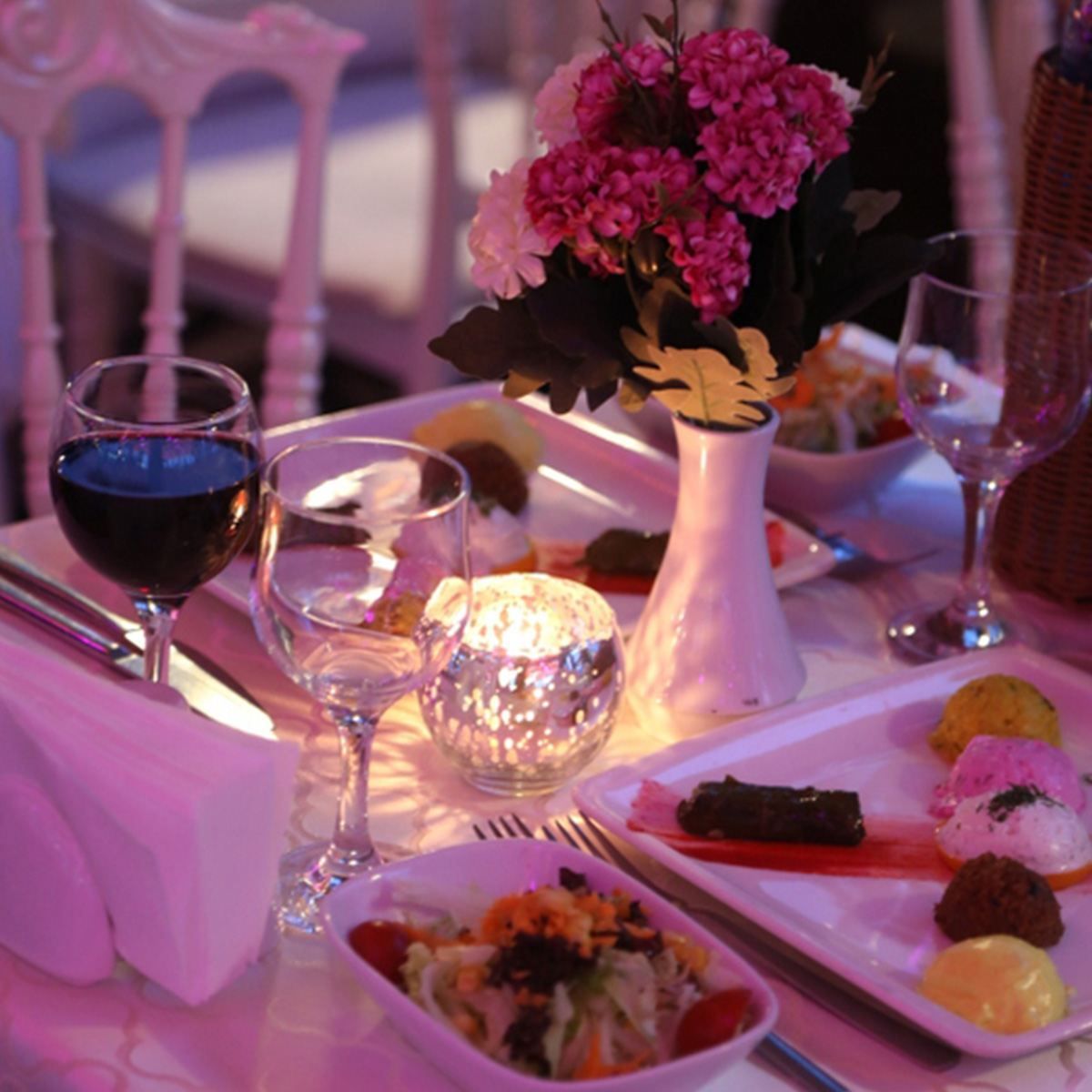 Romantic candlelit table with wine and appetizers